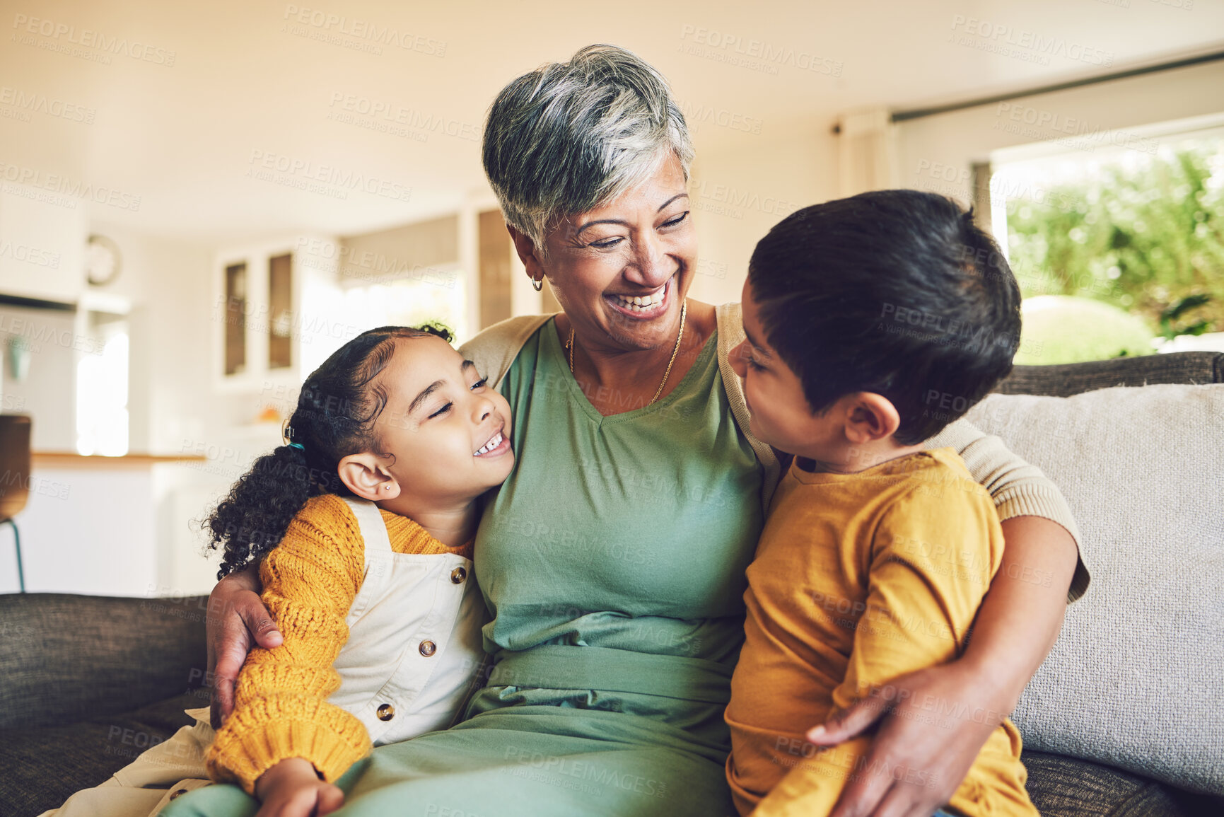 Buy stock photo Hug, grandmother or happy kids on a sofa with love enjoying quality bonding time together in family home. Smile, affection or funny senior grandparent with children siblings on house couch laughing 