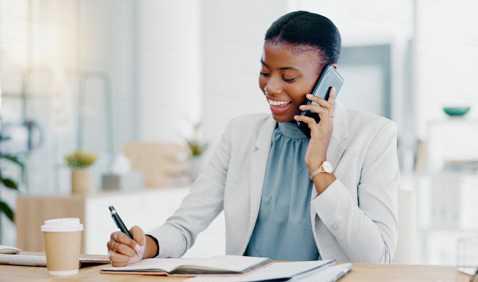 Buy stock photo Black woman, phone call and writing in book consulting for financial advice, conversation or communication at office. Happy African female accountant talking on smartphone checking data on computer