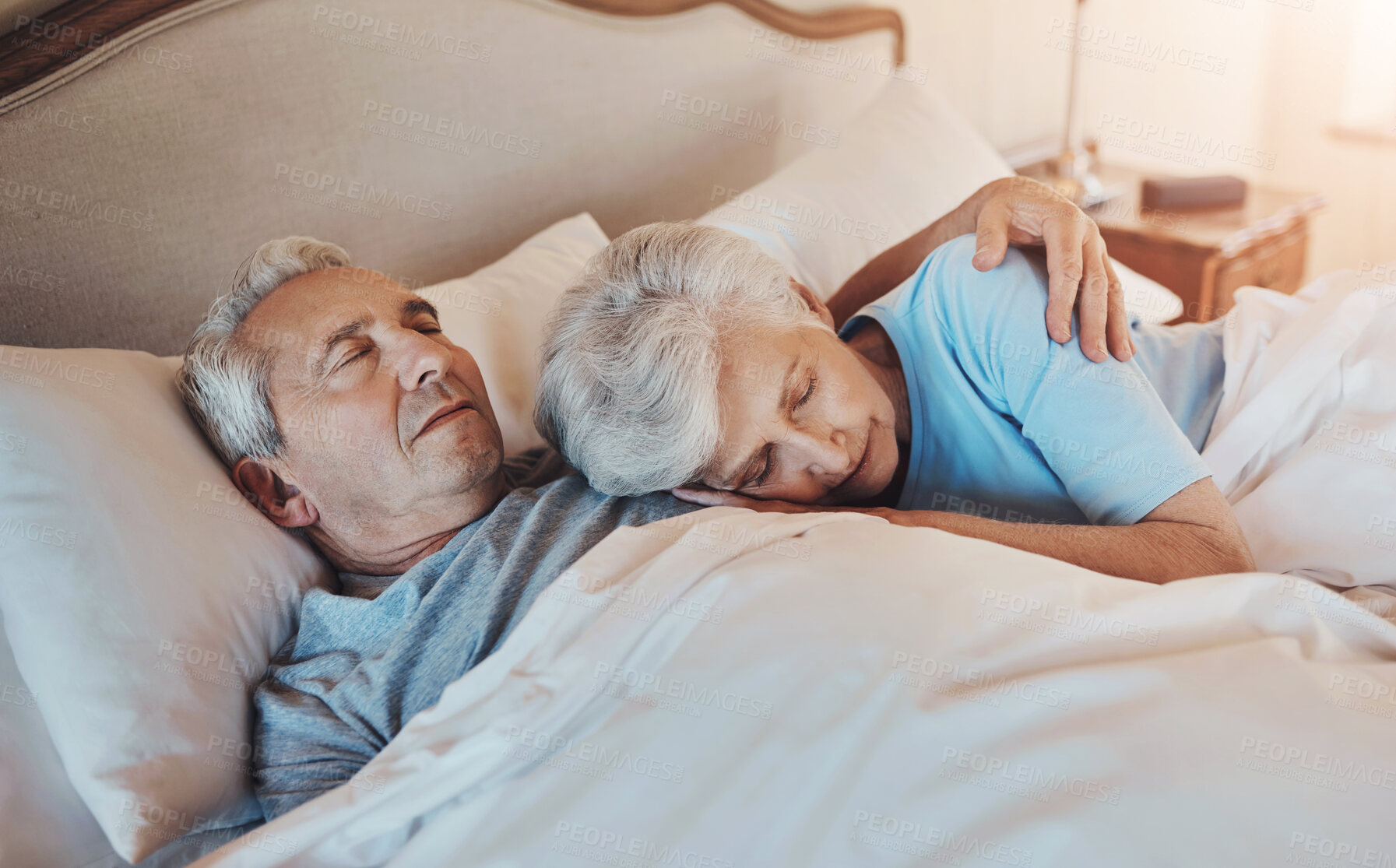 Buy stock photo Senior couple, sleeping and bed with retirement, dream and rest in the morning in a nursing home. Marriage, care and love with nap together in bedroom with cuddle, embrace and people with peace