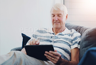 Buy stock photo Senior man, tablet and retirement home with digital news or puzzle app with game on sofa. Online, tech and living room with internet scroll and search for social media setup advice with smile