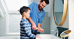 Father, child and helping to washing hands in bathroom for hygiene, learning and health of cleaning safety. Man, boy and wellness support to stop bacteria, virus protection and bonding at house