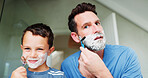 Shaving cream, bathroom and dad with boy for skincare, happy and playful practice for growth or development. Father, dad and together in home for learning facial care, grooming and bonding with love.