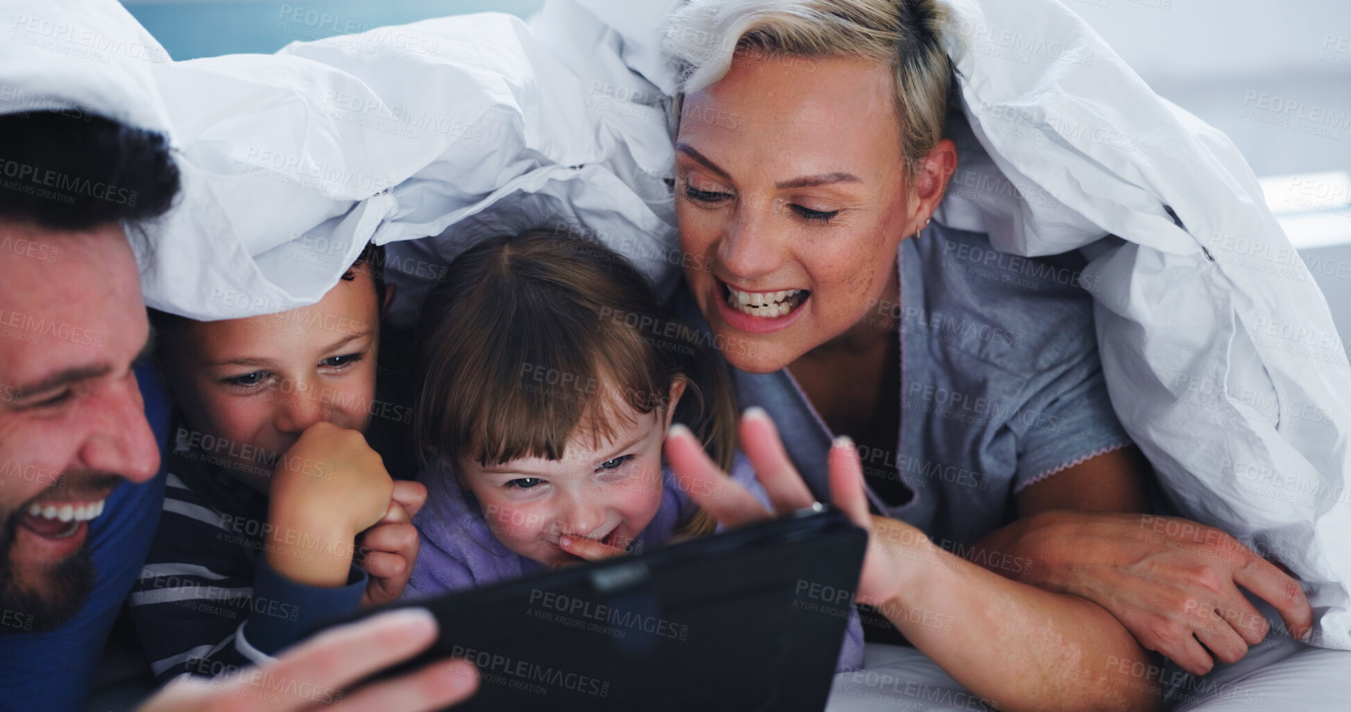 Buy stock photo Family, tablet and laughing with blanket in home for comedy movie, video and funny show with subscription. People, parents and kids with digital app for streaming cartoon, media and relax with duvet