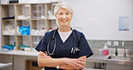 Confident, mature and woman with portrait in vet for professional career in animal care, welfare and wellness. Veterinarian, pet doctor and arms crossed with pride for expert support in healthcare.