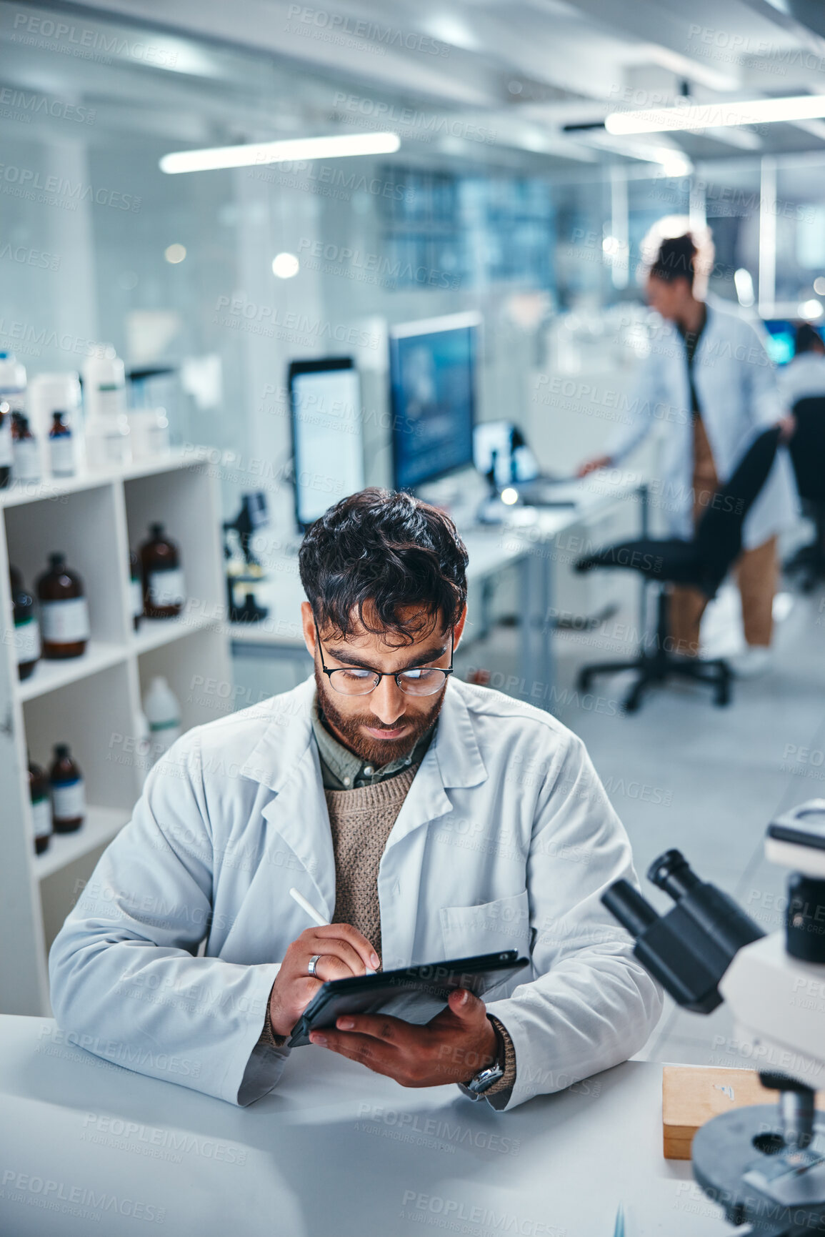 Buy stock photo Scientist, man and writing on tablet in lab for microscope research, medical data and science information. Person, researcher and digital for study feedback, vaccine solution and biotechnology cure