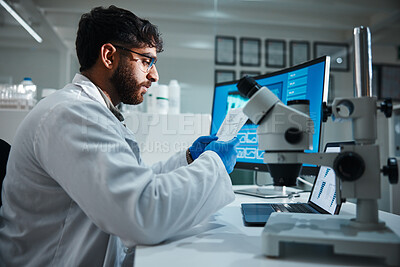 Buy stock photo Computer screen, paper and science with man in laboratory for development, innovation or research. Microscope, results and study with scientist reading at work on medical breakthrough or discovery