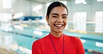 Smile, woman and portrait of swimming instructor at indoor pool for lesson, workout or training. Happy, confident and female coach from Canada with pride for competition practice at aquatic center