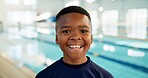 Boy, black child and happy with portrait by pool for indoor swimming lessons, skill development and muscle growth. Male kid, water sports and student for learning, progress and improvement by school.