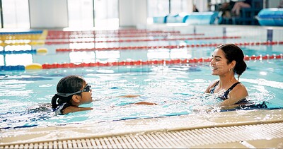 Buy stock photo Instructor, smile and child in pool, swimming and teaching of woman, proud or helping girl in water. Bathing suit, happy and learning with teacher in school for training of kid, sports or competition