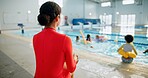 Lifeguard, woman and supervision at swimming pool with duty for children safety, monitoring and protection. Recreation, person and back with watching kids in water for helping, lifesaver and rescue