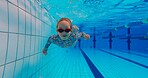 Girl, underwater and swimming in pool for childhood, wellness and health by indoor aquatic facility as activity. Child, bubbles and training in water for school sports, learning and development