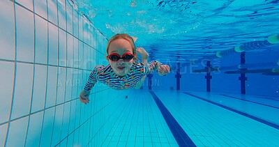 Buy stock photo Girl, underwater and swimming in pool for childhood, wellness and health by indoor aquatic facility as activity. Child, bubbles and training in water for school sports, learning and development