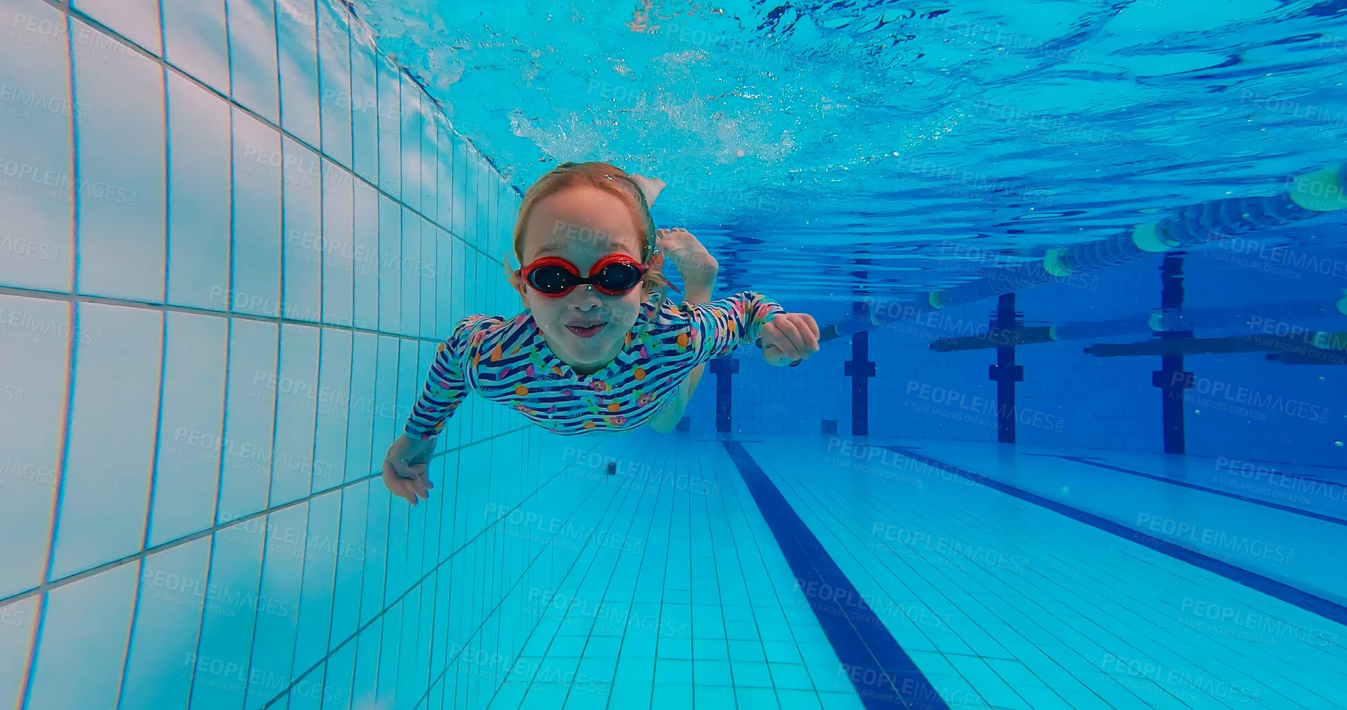 Buy stock photo Girl, underwater and swimming in pool for childhood, wellness and health by indoor aquatic facility as activity. Child, bubbles and training in water for school sports, learning and development