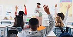 Children, back and hands raised in classroom with for question, answer and learning at youth academy. Kids, education and development with sign for talking, quiz and scholarship at private school