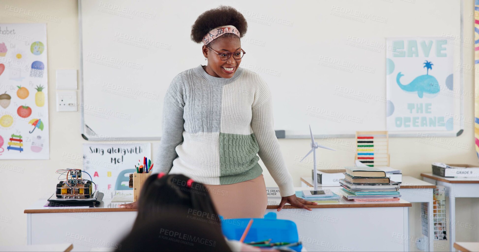 Buy stock photo Teacher, black woman and smile in classroom for learning, education and development of pupils. Female person, happy and climate change awareness for kids, scholars or learners in elementary school