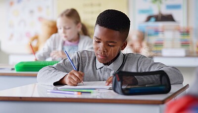 Buy stock photo African boy, writing and test in classroom for learning, knowledge and info for assessment at youth academy. Child, paper and education with scholarship, studying and exam for development at school