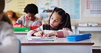 Girl, child and writing with notebook in classroom for learning, knowledge and info for assessment. Kid, paper and education for scholarship, studying or notes with lesson for development at school