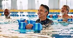 Dumbbell, group and mature woman in swimming pool for exercise, healthy body and strong muscle. Aqua therapy, water and aerobics class for fitness, physiotherapy or rehabilitation of senior person