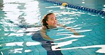 Swimming pool, woman and fitness with smile, exercise and recreation with wellness, joy and physical therapy. Person, playful and girl with water aerobics, healthy and cardio workout with activity