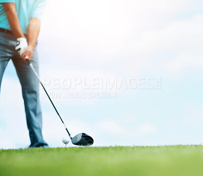 Buy stock photo Cropped image of a young male golfer teeing up to play a shot with his driver