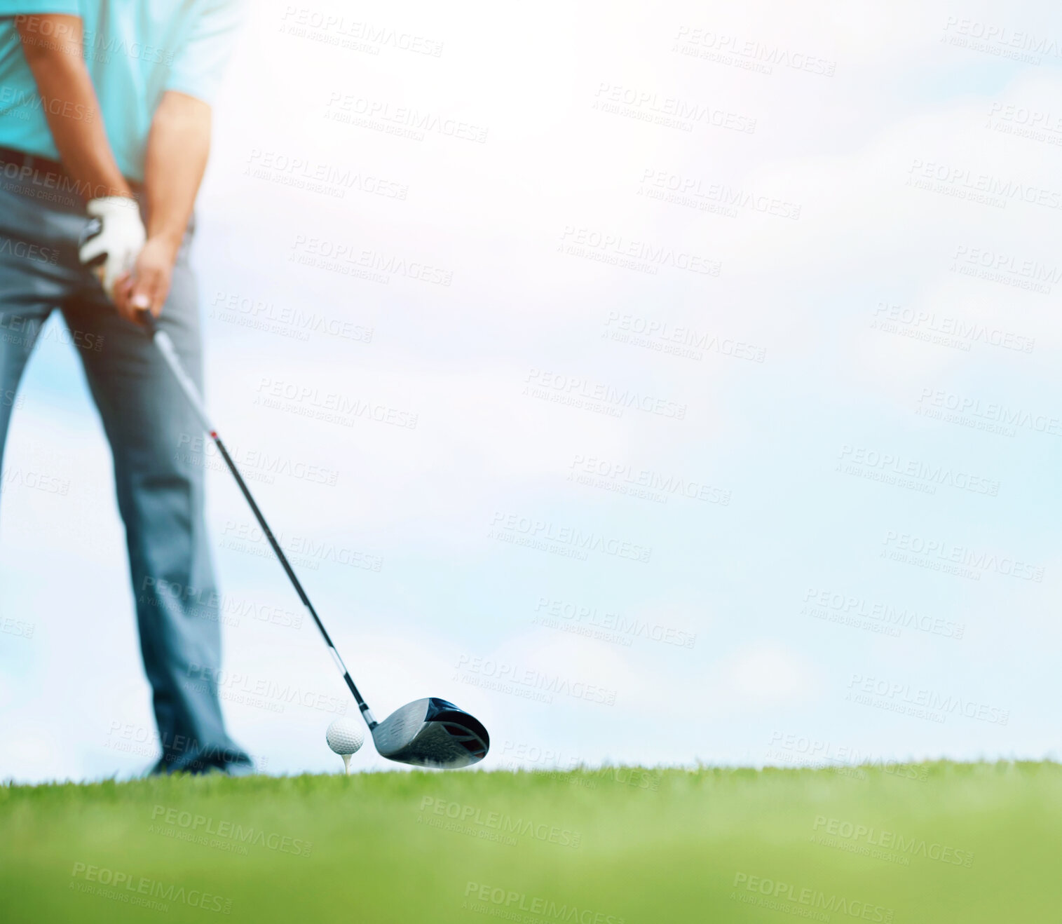 Buy stock photo Cropped image of a young male golfer teeing up to play a shot with his driver