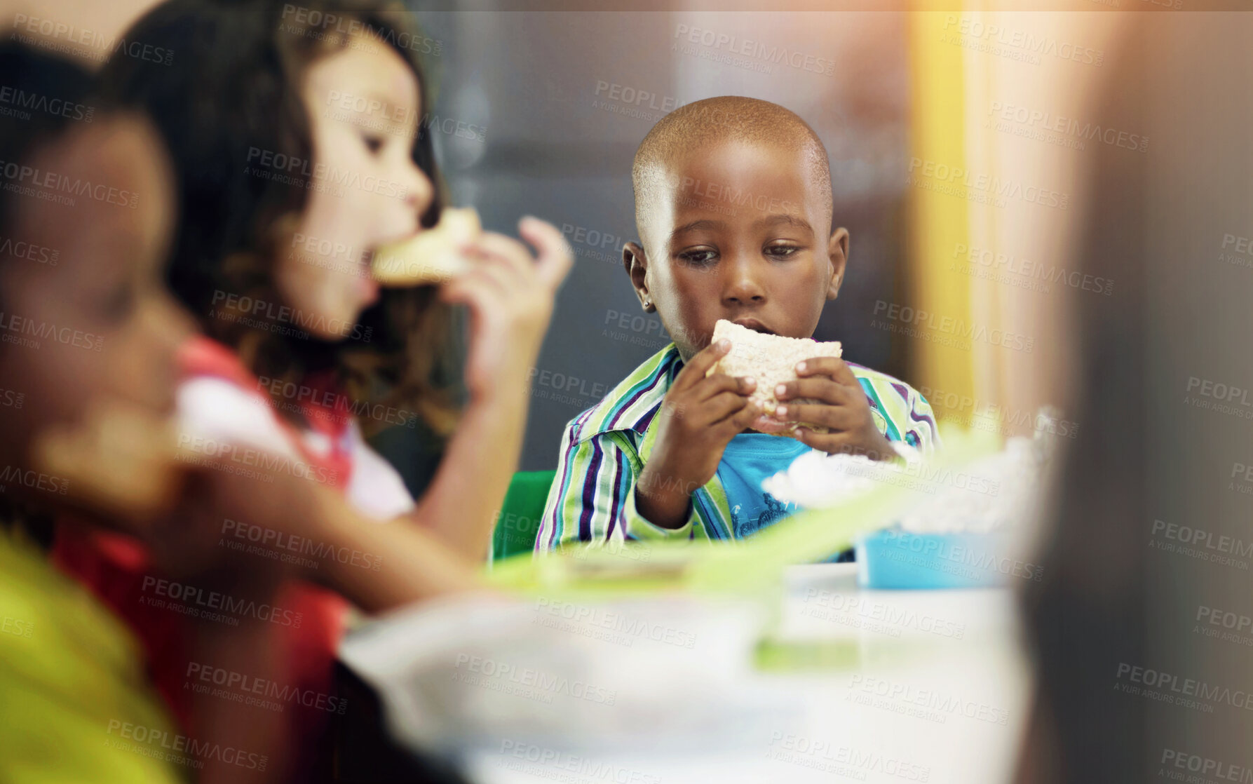 Buy stock photo Eating, boy and children class for lunch at school or creche for an education or to learn. Break, kid and sandwich in a classroom to eat or learning or hungry at desk for nutrition with friends.