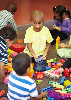 Buy stock photo Play time for a group of young children who are playing with plastic blocks