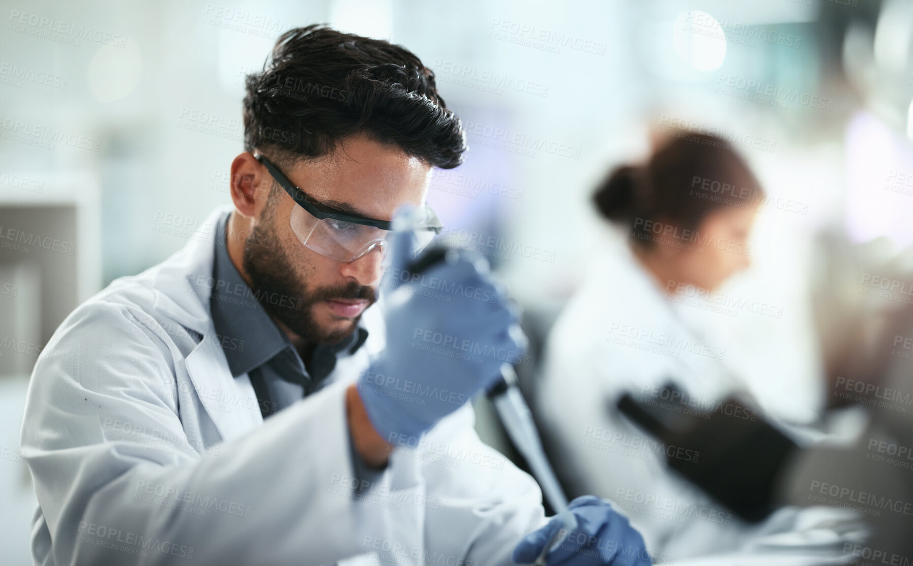 Buy stock photo Science, research and man with dropper in lab for sample, inspection or pharmaceutical development. Scientist, PPE and investigation with pipette for chemistry study, innovation or antiviral compound