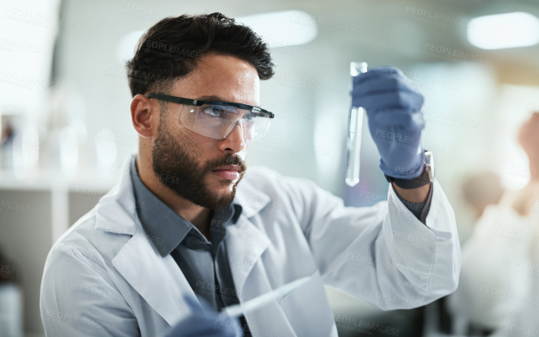 Buy stock photo Science, research and man with test tube in lab for solution, medical and pharmaceutical study. PPE, scientist and idea with glass vial for chemistry development, innovation and antiviral compound