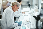 Clipboard, woman and scientist writing in laboratory for medical research on cancer drug trial. Checklist, investigation and female biologist with clinic protocol development for pharmaceutical study