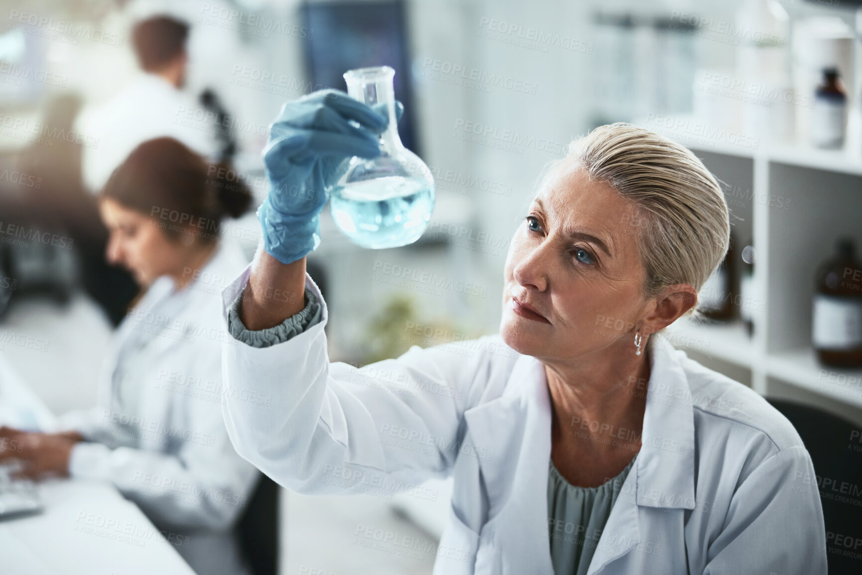 Buy stock photo Science, research and woman with beaker in lab for solution, inspection or pharmaceutical study. Scientist, PPE and analysis of glass container for chemical test, investigation and antiviral compound