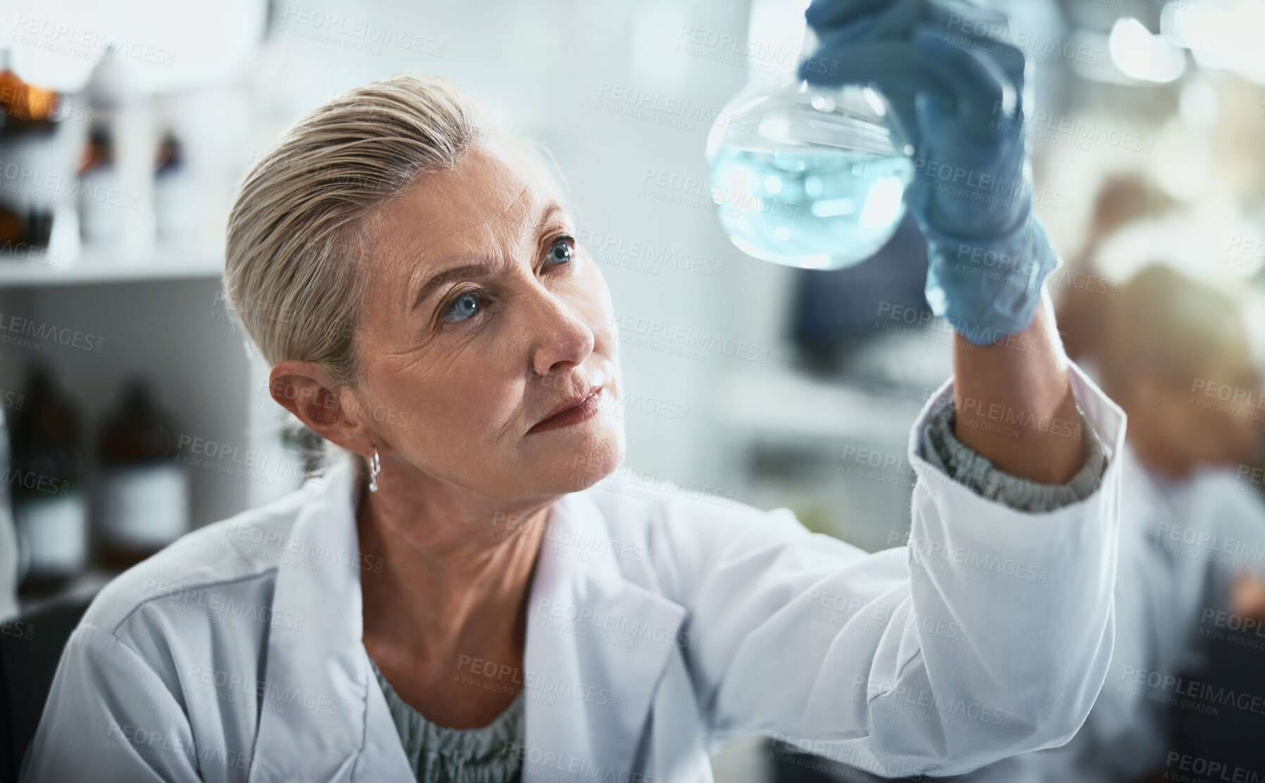 Buy stock photo Scientist, research and woman with beaker in lab for inspection, solution or pharmaceutical study. Science, PPE and analysis of glass container for chemical investigation, test and antiviral compound