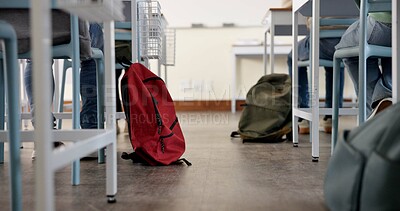 Buy stock photo Classroom, backpack and education in school, students and low angle of learning of kids in academy. Desk, legs and  children with scholarship, studying and writing of practice exam, bag and knowledge