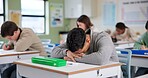 Exam, boy and tired on desk with stress, overwhelmed and brain fog in classroom. Student, depression and overthinking in test with anxiety, burnout and mental health fatigue in high school lesson 