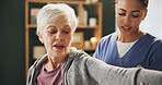 Women, physiotherapist and senior patient with stretching arm for rehabilitation, support and healthcare. People, nursing home and happy for fitness, exercise and training for arthritis and wellness