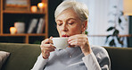 Senior woman, sofa and drinking coffee on break to relax, chill and me time at nursing home. Female person, living room and eyes closed with tea on couch as pensioner to enjoy, wellness and self care