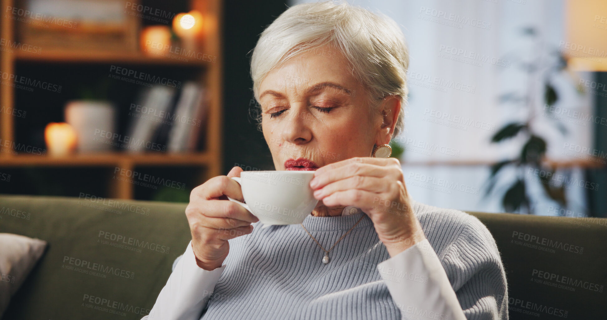 Buy stock photo Senior woman, sofa and drinking coffee on break to relax, chill and thinking at nursing home. Female person, living room and eyes closed with tea on couch as pensioner to enjoy, wellness or self care