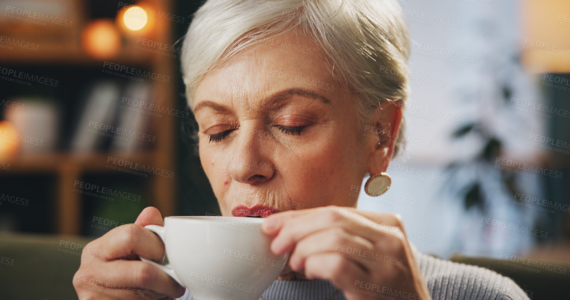 Buy stock photo Senior woman, eyes closed and drinking coffee on break to relax, chill and me time at nursing home. Female person, living room and sofa with tea on couch as pensioner to enjoy, wellness and self care