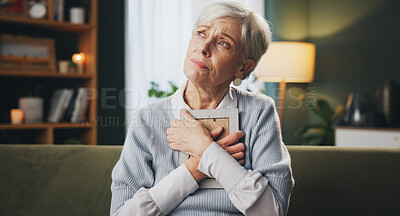 Buy stock photo Photograph, sad and thinking with senior woman on sofa in living room of retirement home for grief. Loss, memory and pain with unhappy elderly person in apartment for mourning, reflection or regret