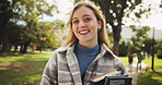 Student, woman and books in portrait, park and happy on walk for education, learning and development at campus. Person, smile and outdoor on path in nature for scholarship at university in Germany