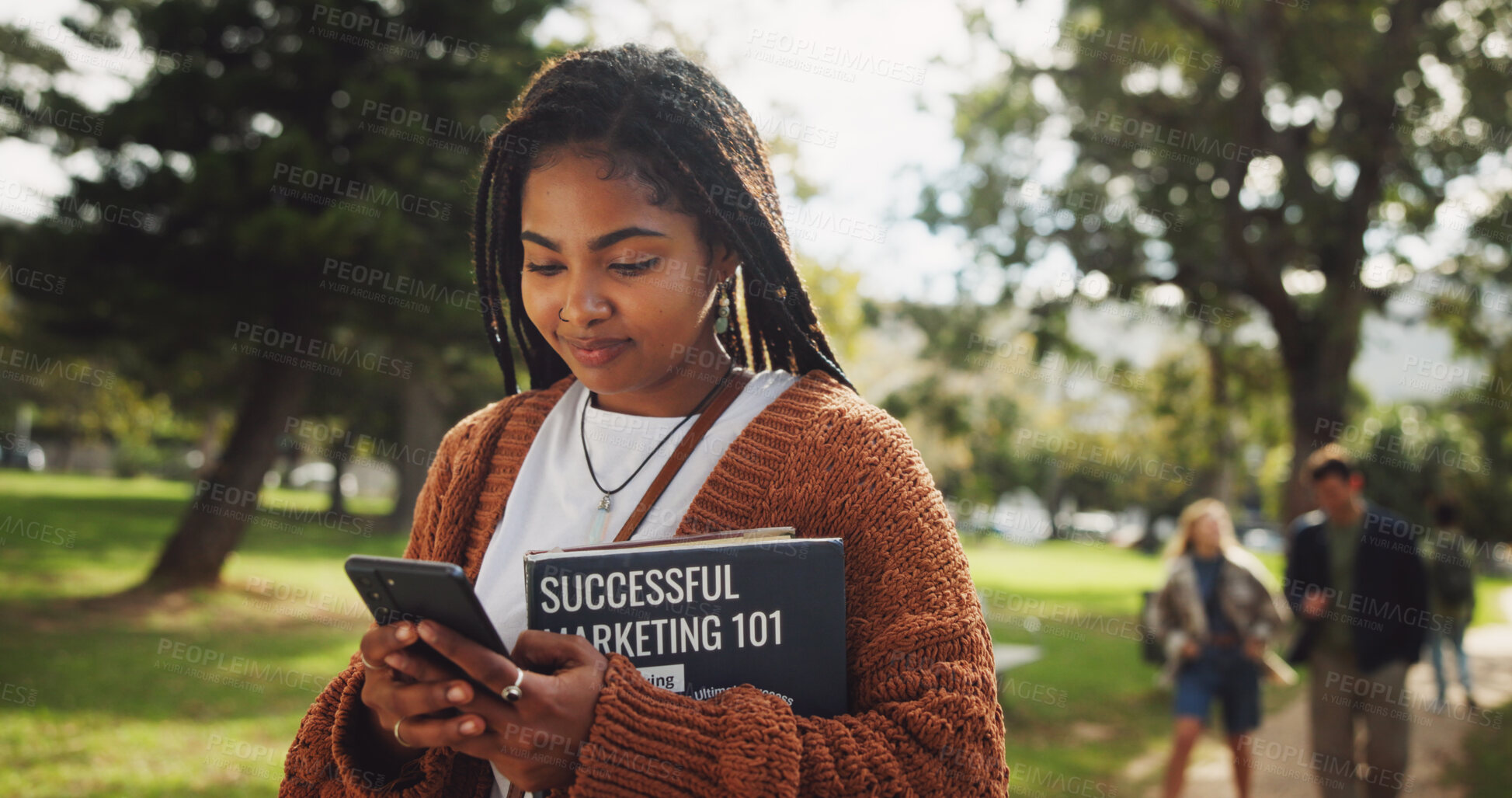 Buy stock photo Student, black woman and books in park with phone on walk for education, learning or web chat at campus. Person, reading and mobile app on path, social media and marketing degree at college in Brazil