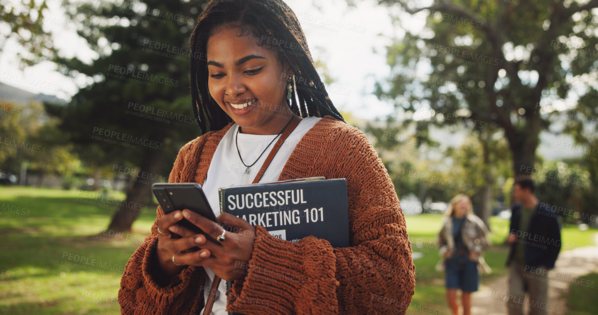 Buy stock photo Student, black woman and books in park on smartphone on walk with education, learning or chat on web at campus. Person, reading and app with smile, social network or marketing at college in Brazil