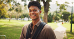 Student, man and smile in portrait, park and walk to class for education, learning and development at campus. Person, happy and outdoor on path with backpack for scholarship at university in Brazil