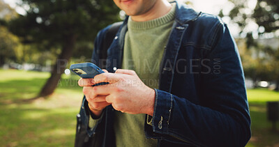 Buy stock photo Student, phone and hands in park for social media, communication and study break with backpack. Man, mobile and online test results at campus, university or college for education, learning and ebook