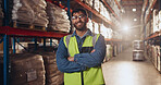 Portrait, arms crossed and man with smile in factory, glasses or proud of supply chain or shipping. Logistics, vision and employee in warehouse for storage of stock, cargo or service of manufacturing