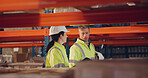 Logistics, colleagues and walking in factory, inspector and inventory of stock for shipping and talking. Communication, helmet and people in warehouse for supply chain, team and inspection of cargo