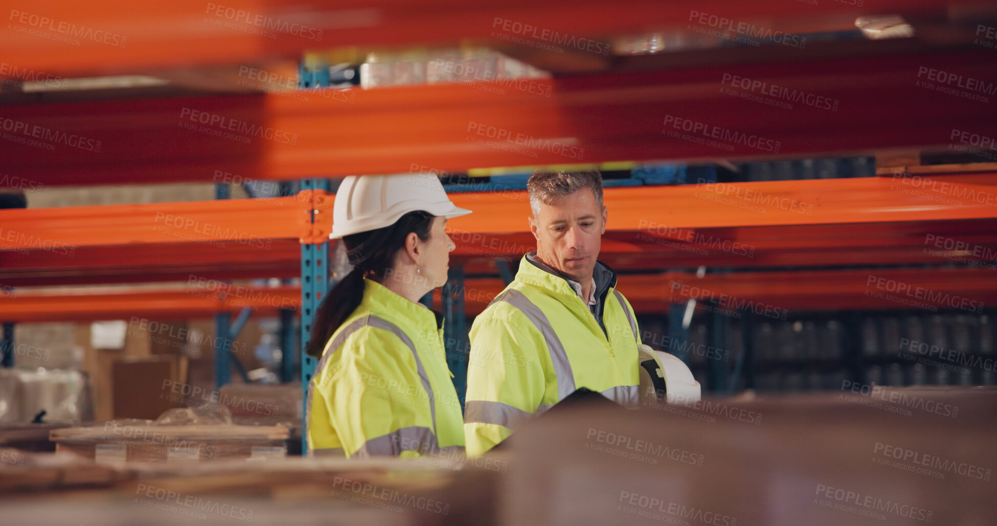 Buy stock photo Logistics, colleagues and walking in factory, inspector and inventory of stock for shipping and talking. Communication, helmet and people in warehouse for supply chain, team and inspection of cargo