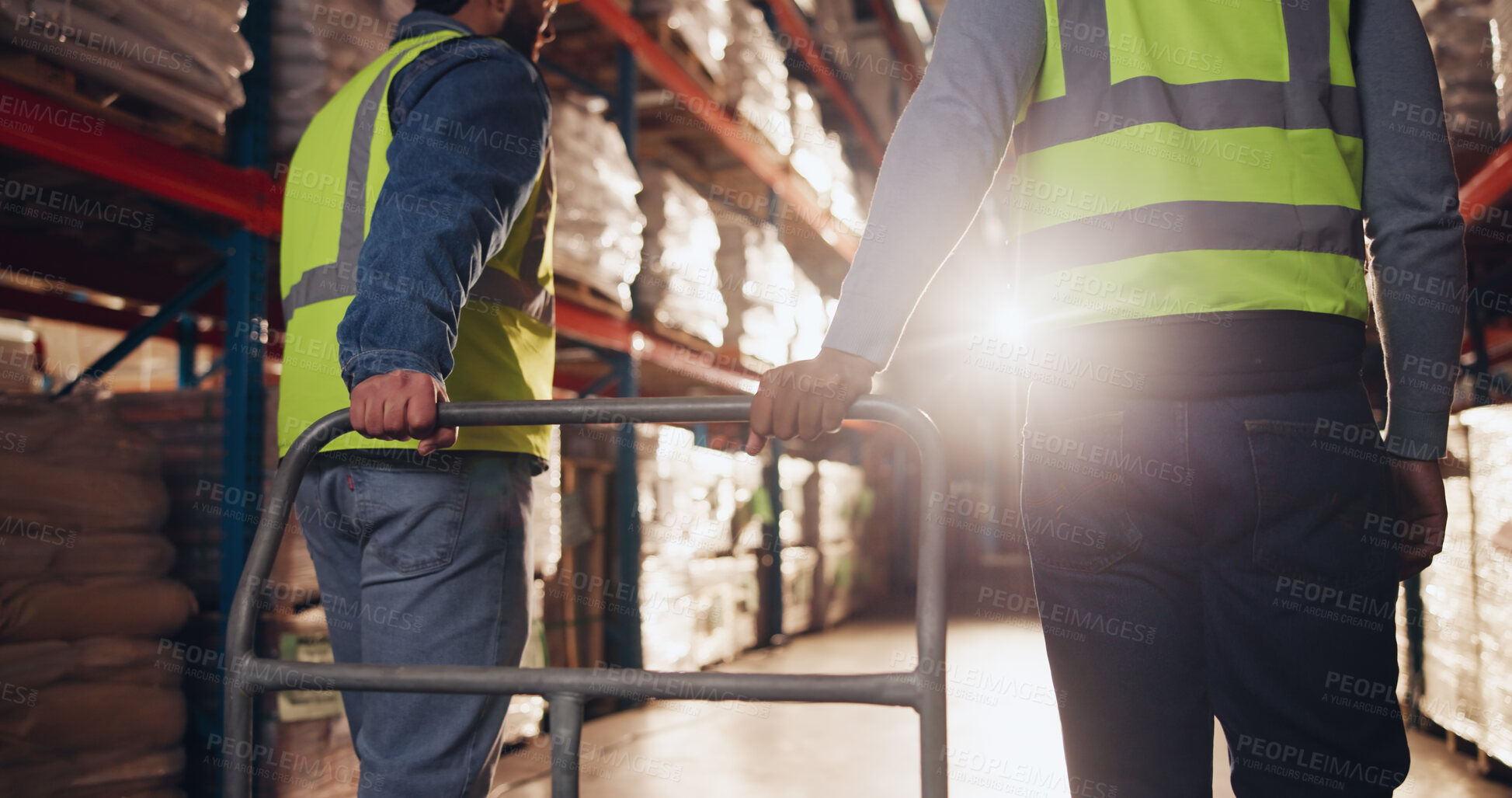 Buy stock photo Trolley, hands and delivery for logistics in warehouse, back view and teamwork for moving of goods or shipping. Distribution, cargo and people in factory for supply chain, walking and storage