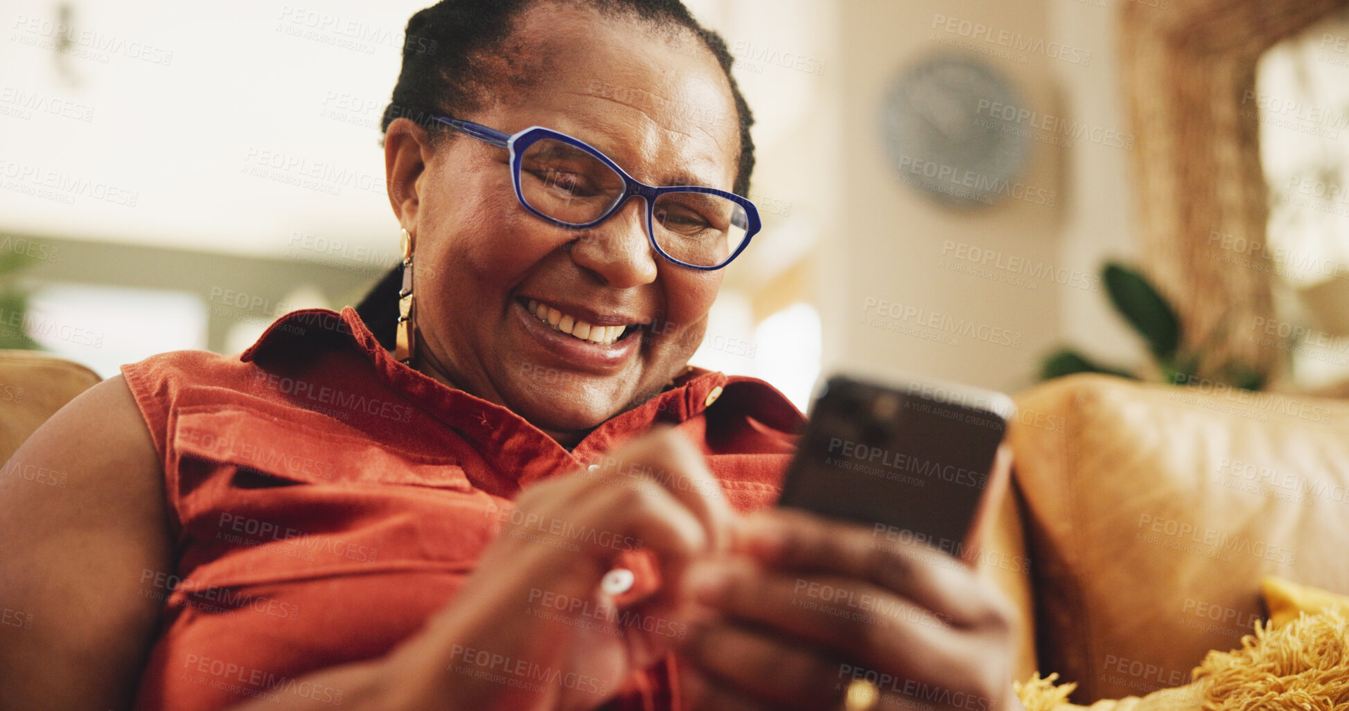 Buy stock photo Senior, black woman and happy on sofa with smartphone for social media meme, browsing internet and comedy videos. Elderly person, laughing and relax in home with mobile for entertainment and text.