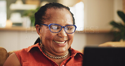 Buy stock photo Happy, relax and mature black woman on laptop in living room for watching movies, video and tv show. Retirement, home and person on computer for online media, entertainment and internet on sofa